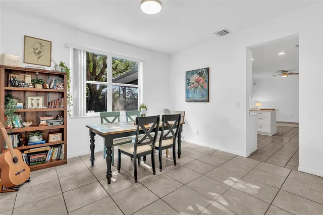 a dining room with furniture and a book shelf