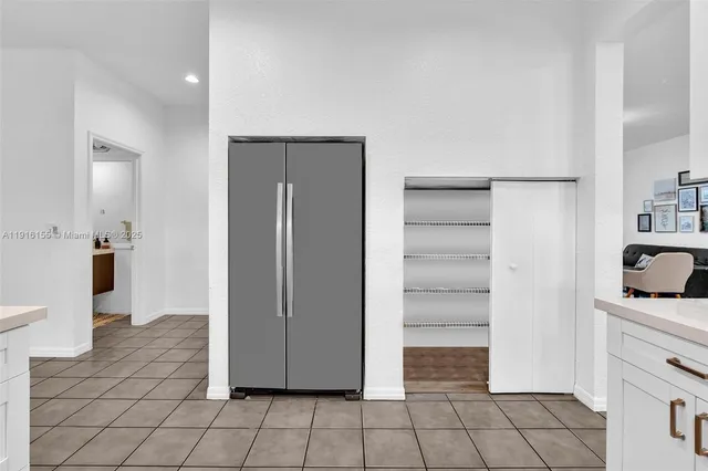 a view of a kitchen with refrigerator and sink