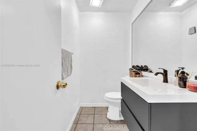 a bathroom with a sink toilet and a mirror