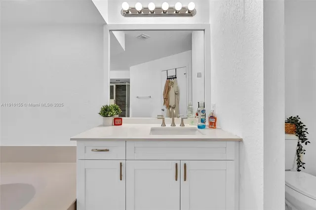 a bathroom with a sink double vanity and a shower