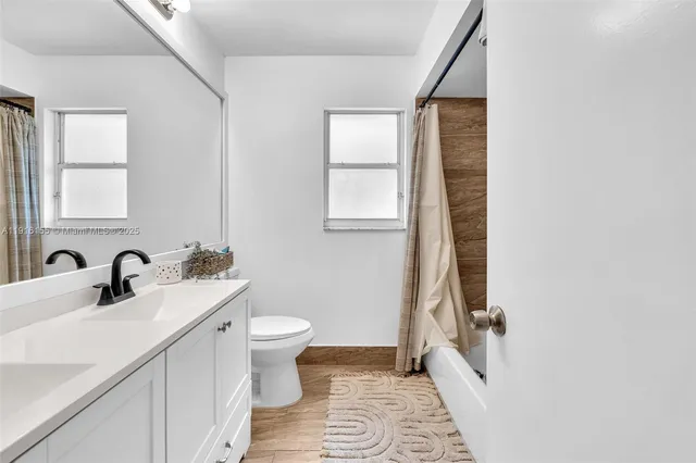 a living room with furniture and a book shelf