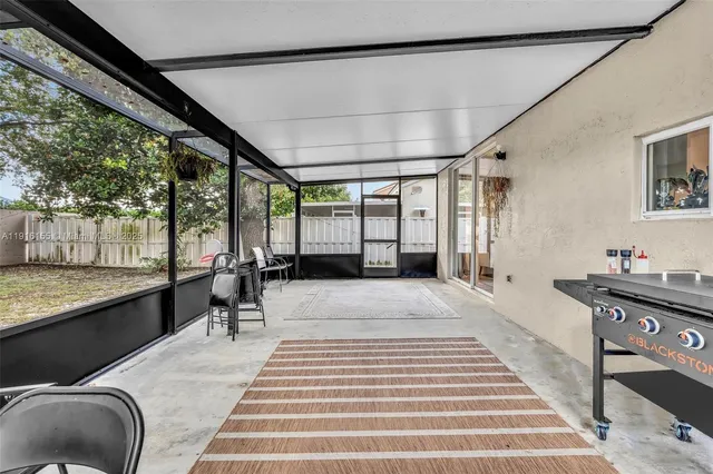 a view of a house with a yard and tree s