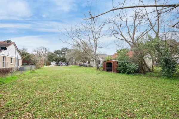 a view of yard with swimming pool and green space