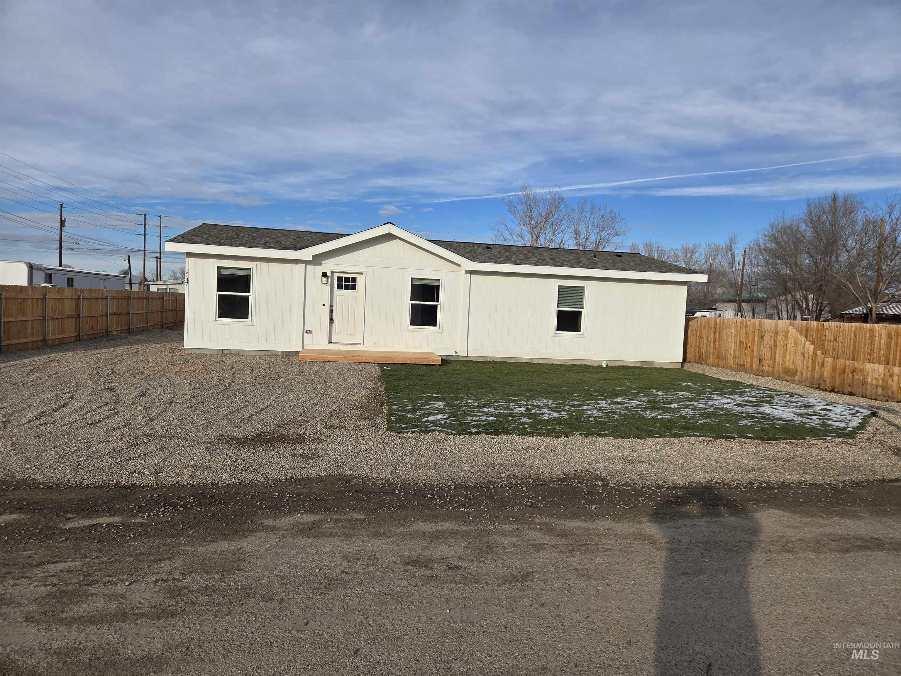 View of front of home featuring a shingled roof
