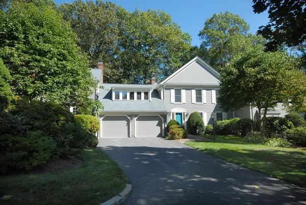 a front view of a house with a garden and plants