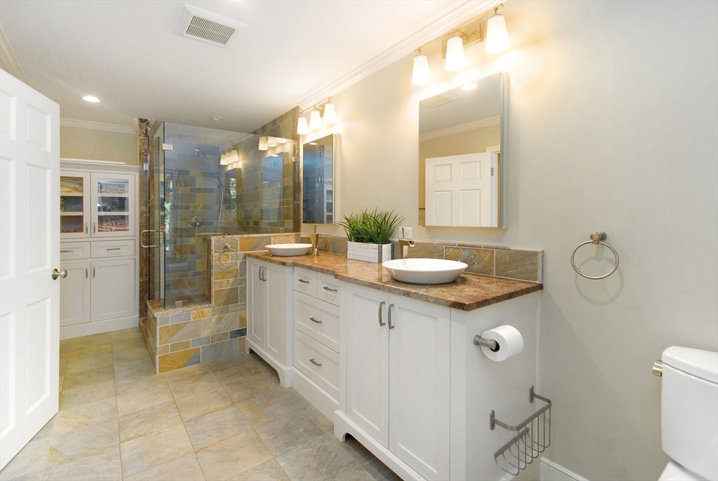 12 South Meadow Ridge, Unit 12 Concord, MA 01742 - Photo 18 of 38 a bathroom with a sink double vanity and a mirror