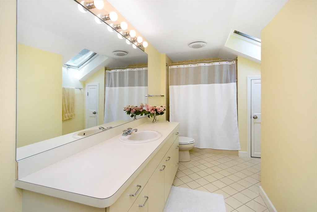 12 South Meadow Ridge, Unit 12 Concord, MA 01742 - Photo 27 of 38 a spacious bathroom with a tub sink and mirror