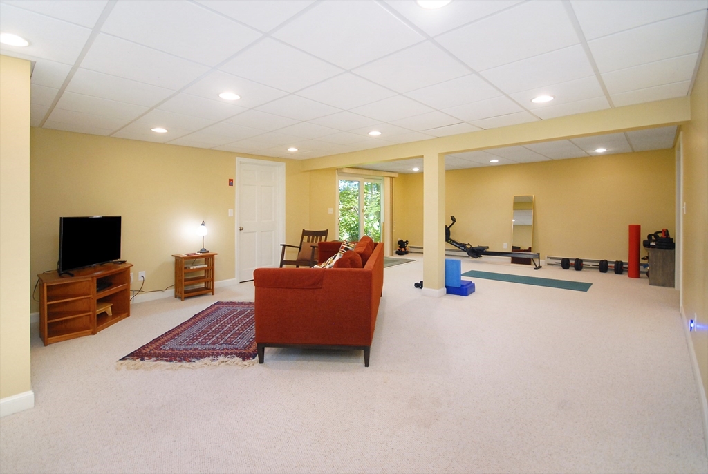 12 South Meadow Ridge, Unit 12 Concord, MA 01742 - Photo 30 of 38 a living room with furniture and a flat screen tv