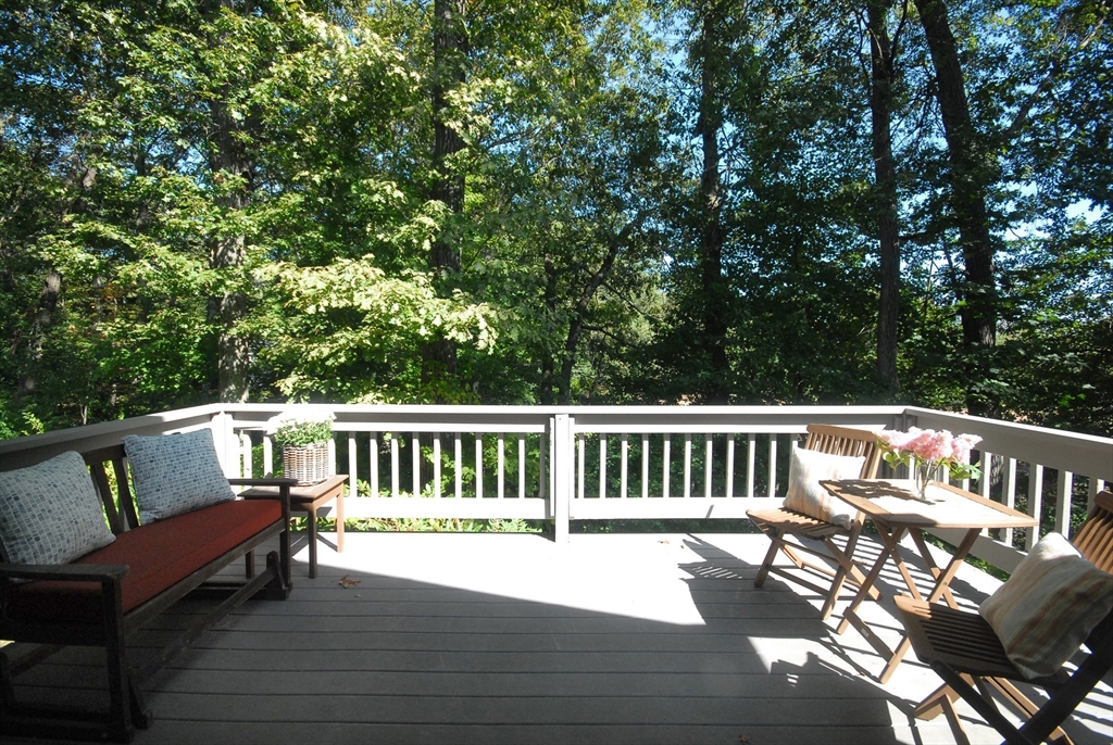 12 South Meadow Ridge, Unit 12 Concord, MA 01742 - Photo 4 of 38 a view of a deck with chairs a barbeque with wooden floor and fence
