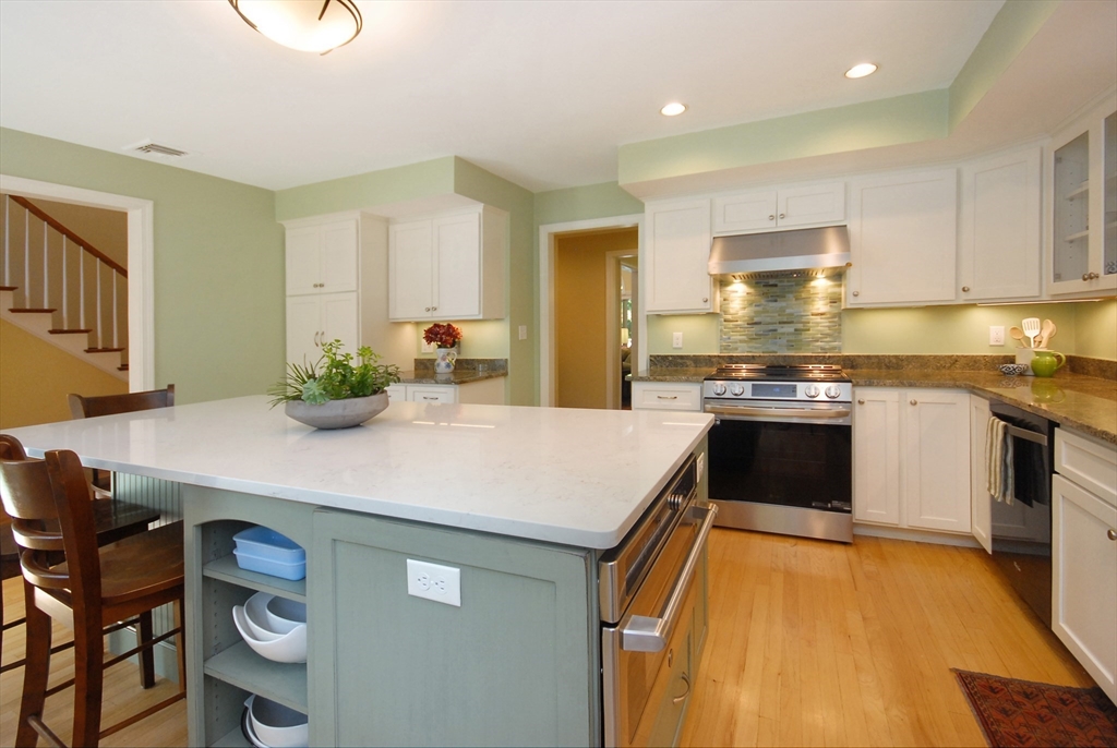 12 South Meadow Ridge, Unit 12 Concord, MA 01742 - Photo 9 of 38 a kitchen with stainless steel appliances granite countertop a stove a sink and a refrigerator
