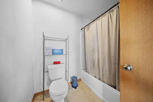 a white toilet sitting next to a bathroom sink