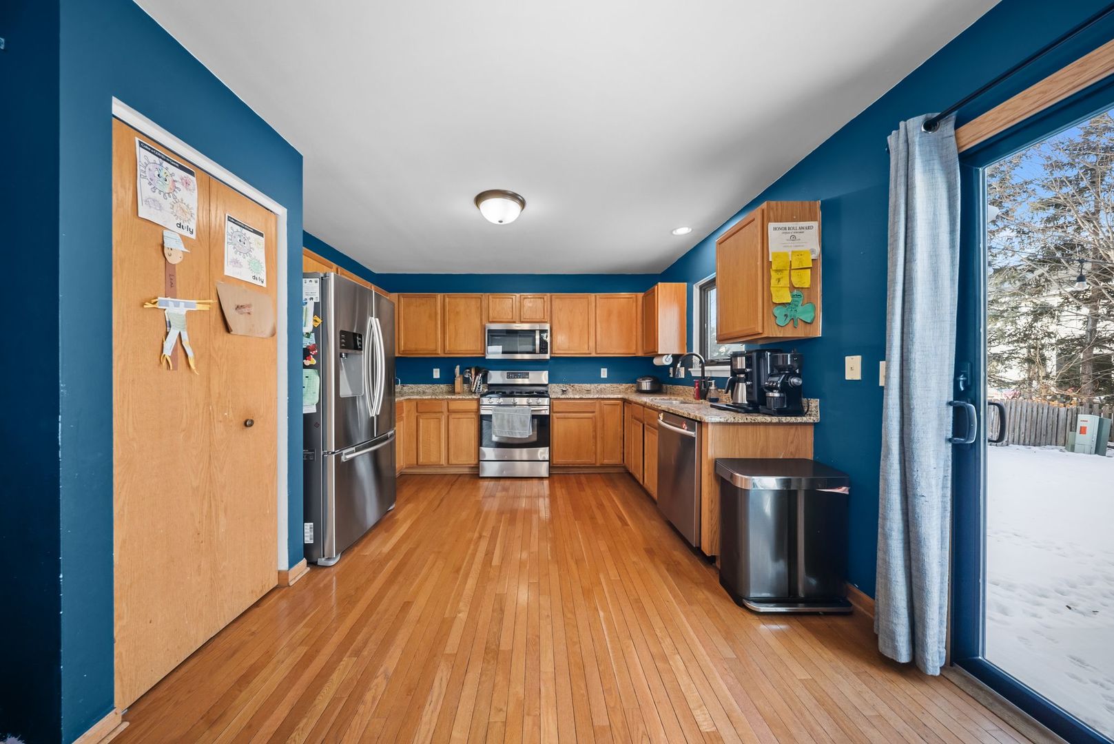 1960 Tuscany Lane Romeoville, IL 60446 - Photo 5 of 24 a kitchen with stainless steel appliances granite countertop a refrigerator a oven a sink with wooden floors and wooden cabinets