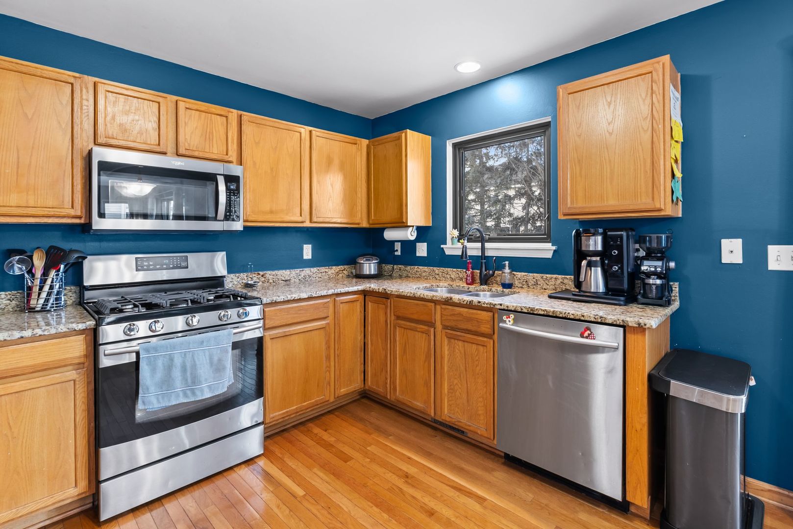 1960 Tuscany Lane Romeoville, IL 60446 - Photo 7 of 24 a kitchen with stainless steel appliances granite countertop wooden cabinets stove top oven and sink