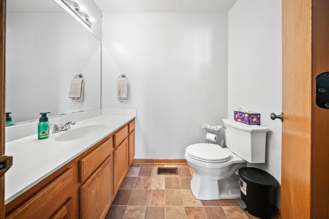 a bathroom with a sink a toilet and a mirror
