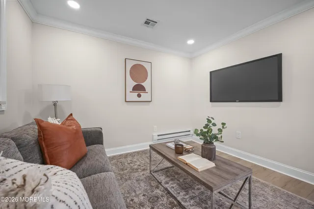 a living room with furniture and a rug