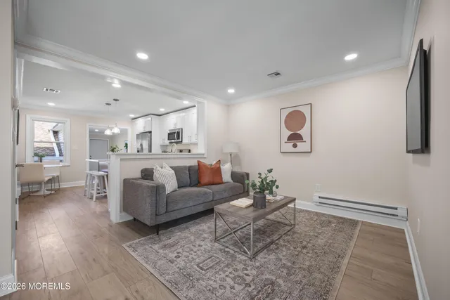 a living room with furniture and wooden floor