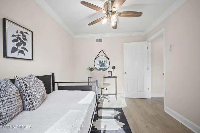 a spacious bedroom with a large bed and a chandelier