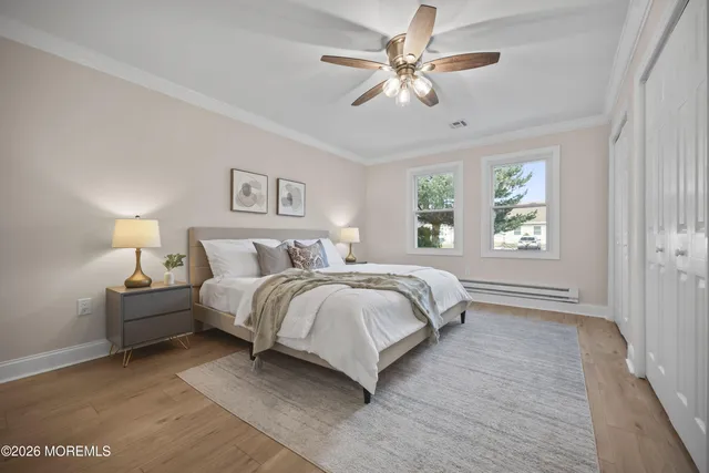 a view of swimming pool with seating area and trees in the background