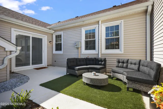 a view of a hallway with wooden floor and a potted plant
