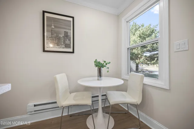 a kitchen with kitchen island white cabinets and stainless steel appliances