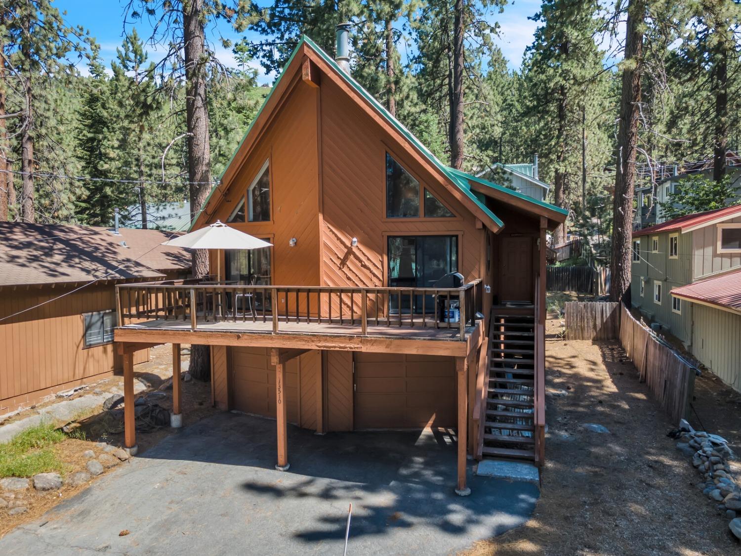 13510 Donner Pass Road Truckee, CA 96161 - Photo 1 of 1 a view of house with yard outdoor seating and barbeque oven