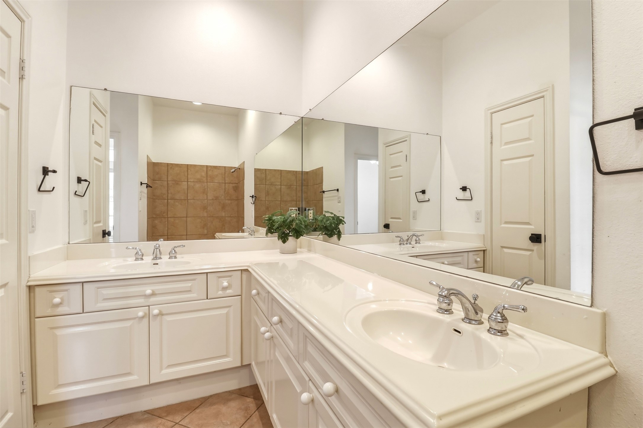 2918 Ranch Road 620, Unit 265 Austin, TX 78734 - Photo 15 of 40 Dual vanities with polished chrome fixtures and extensive mirror space define this functional primary bathroom.