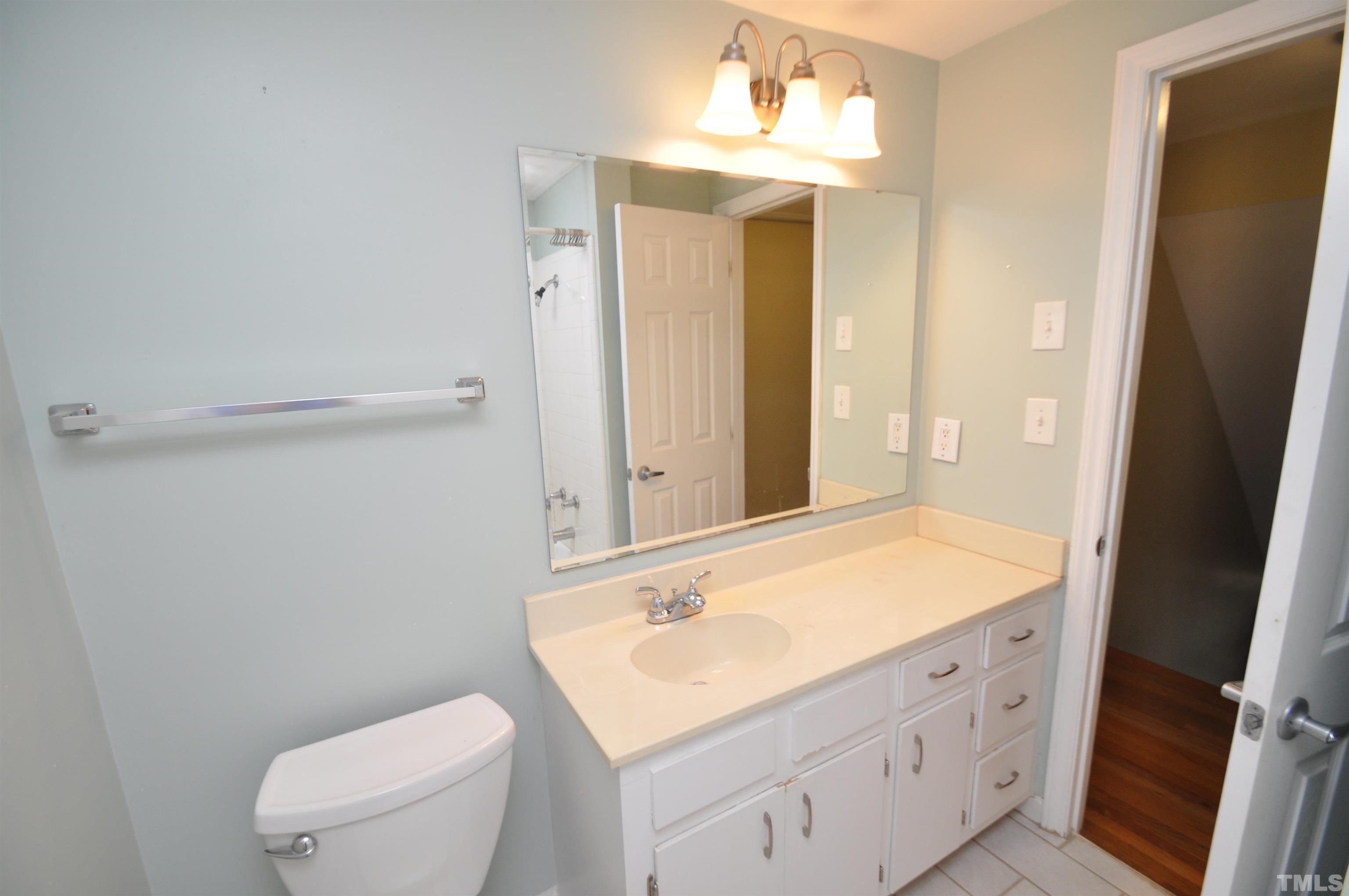 1603 Sutton Drive, Unit 2 Raleigh, NC 27605 - Photo 11 of 22 a bathroom with a sink a toilet and shower