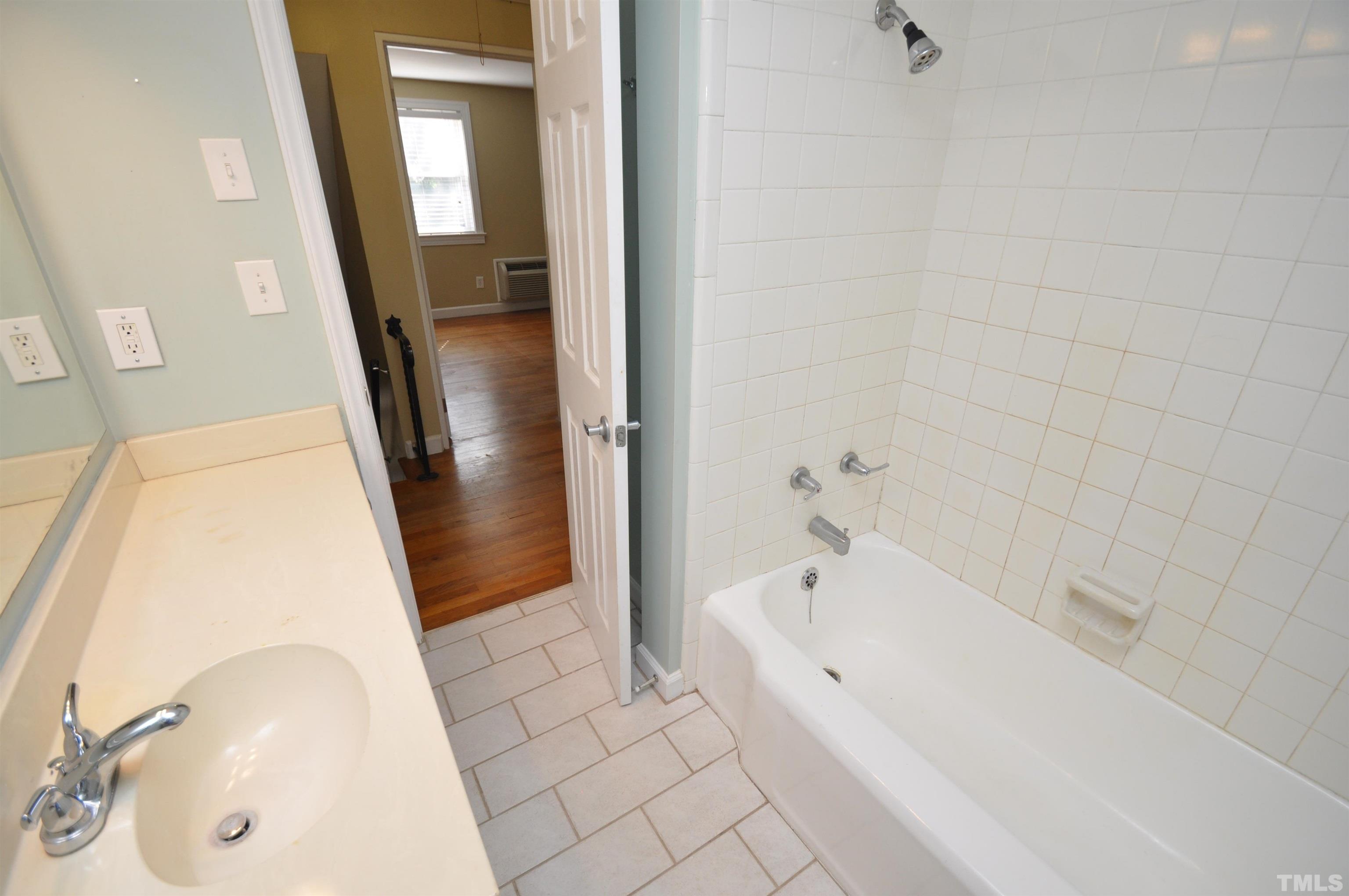1603 Sutton Drive, Unit 2 Raleigh, NC 27605 - Photo 12 of 22 a bathroom with a tub sink and a mirror