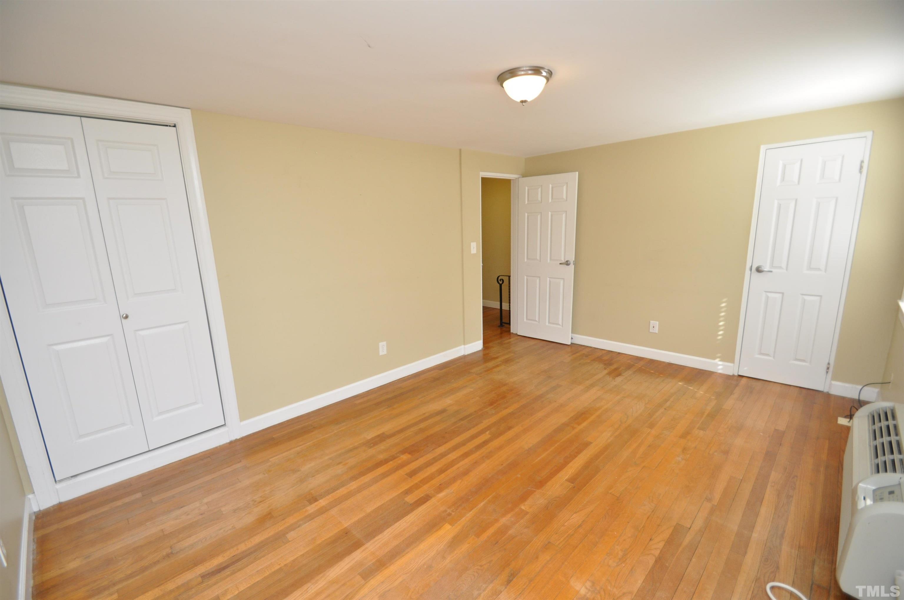 1603 Sutton Drive, Unit 2 Raleigh, NC 27605 - Photo 15 of 22 a view of an empty room with wooden floor