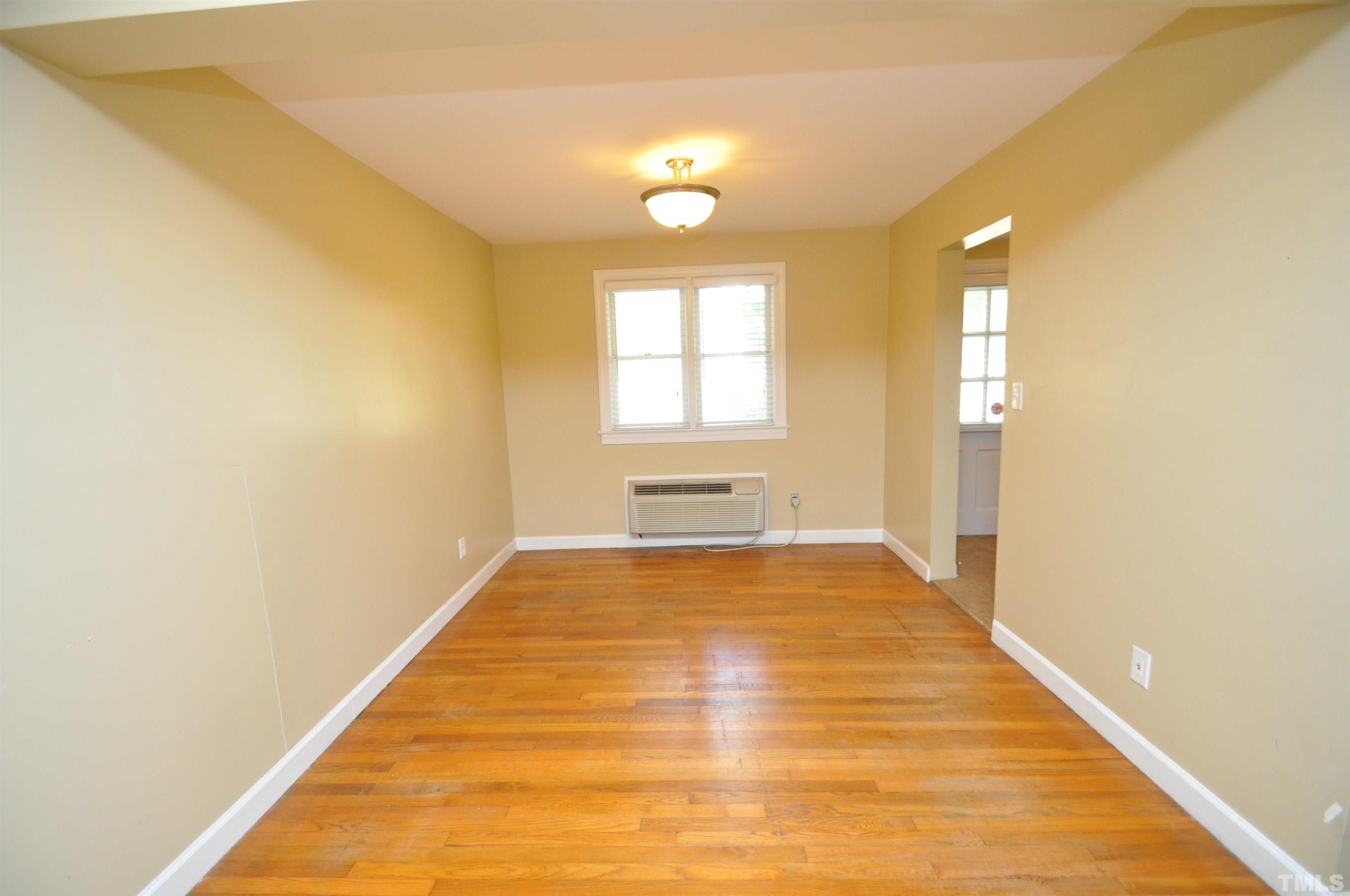 1603 Sutton Drive, Unit 2 Raleigh, NC 27605 - Photo 5 of 22 a view of empty room with wooden floor and fan