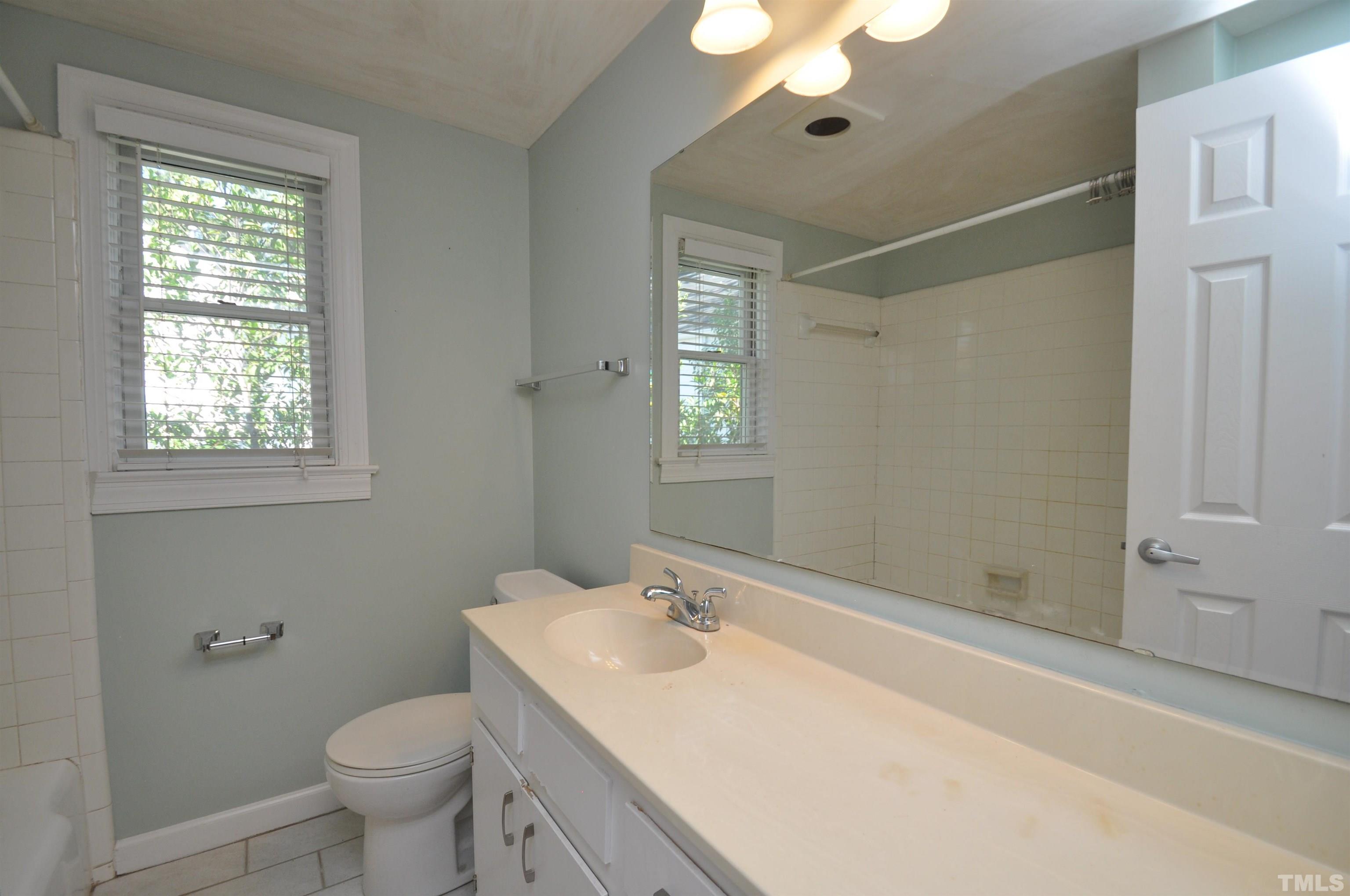 1603 Sutton Drive, Unit 2 Raleigh, NC 27605 - Photo 10 of 22 a bathroom with a sink toilet and shower