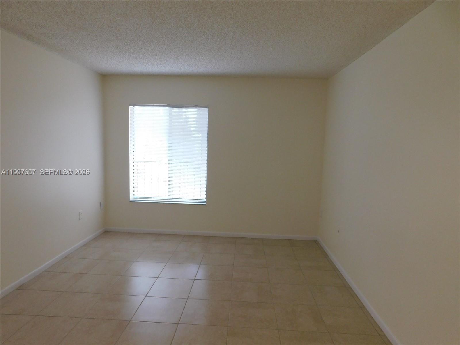 8065 Southwest 107th Avenue, Unit 321 Miami, FL 33173 - Photo 11 of 19 an empty room with a window