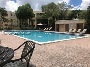 8065 Southwest 107th Avenue, Unit 321 Miami, FL 33173 - Photo 4 of 19 a view of a house with swimming pool and sitting area