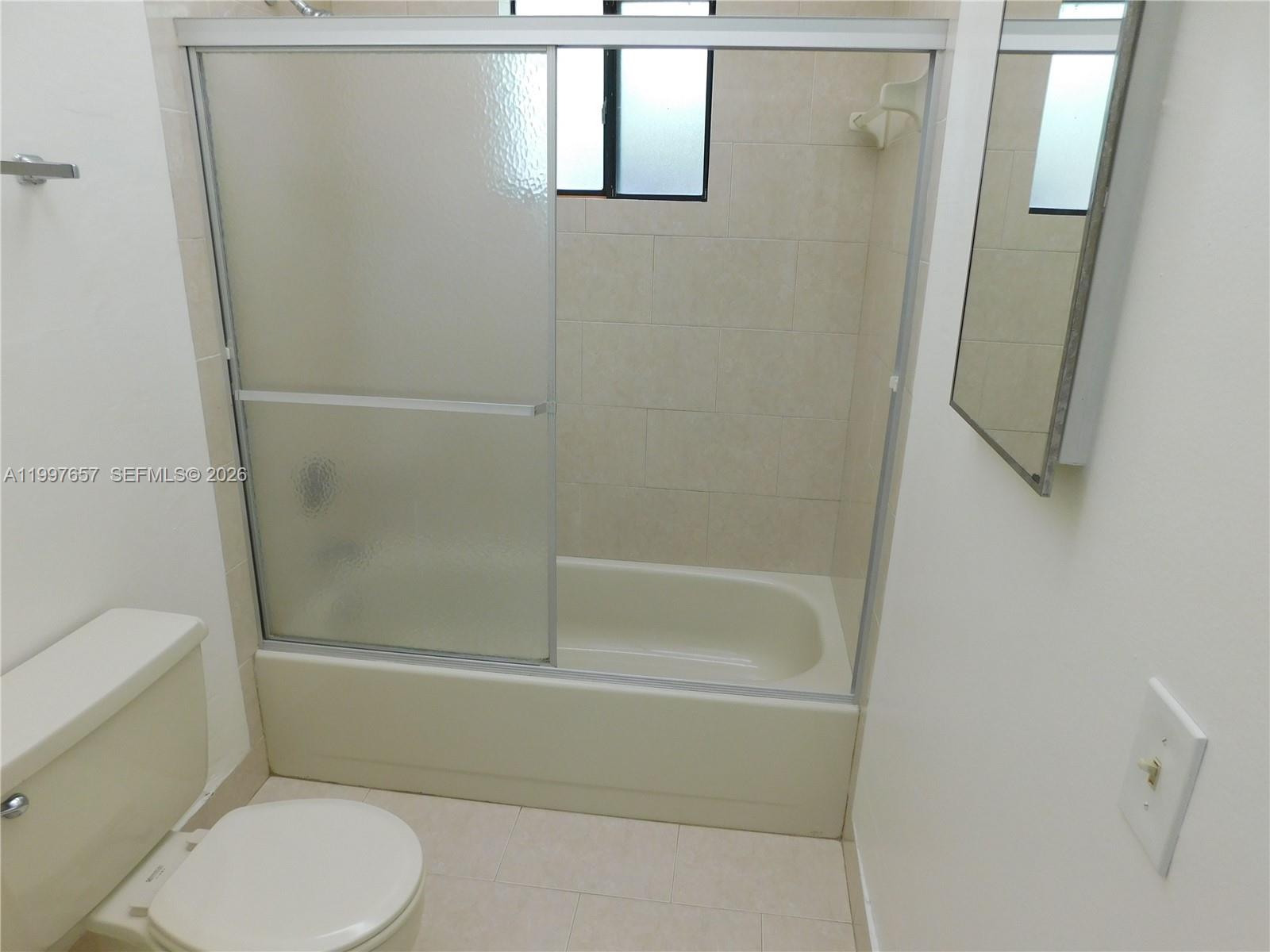 8065 Southwest 107th Avenue, Unit 321 Miami, FL 33173 - Photo 8 of 19 a bathroom with a toilet and shower