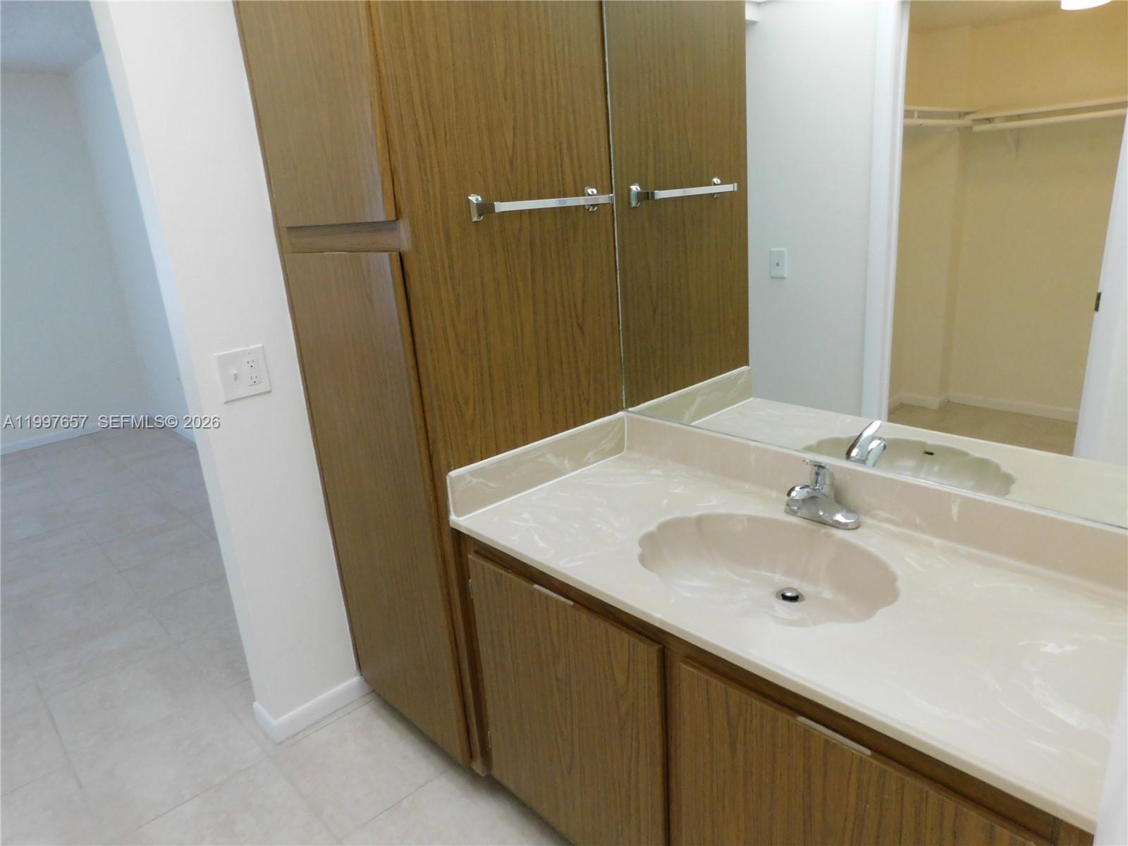 8065 Southwest 107th Avenue, Unit 321 Miami, FL 33173 - Photo 9 of 19 a bathroom with a sink and a mirror