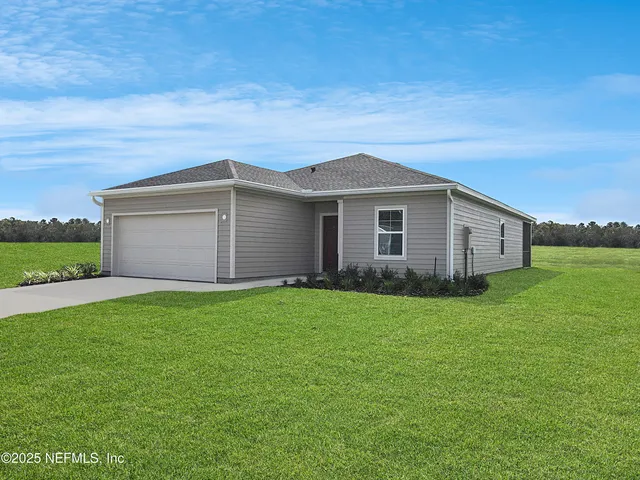 a front view of house with yard barbeque oven and green space