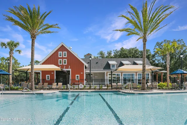 a front view of a house with swimming pool having outdoor seating