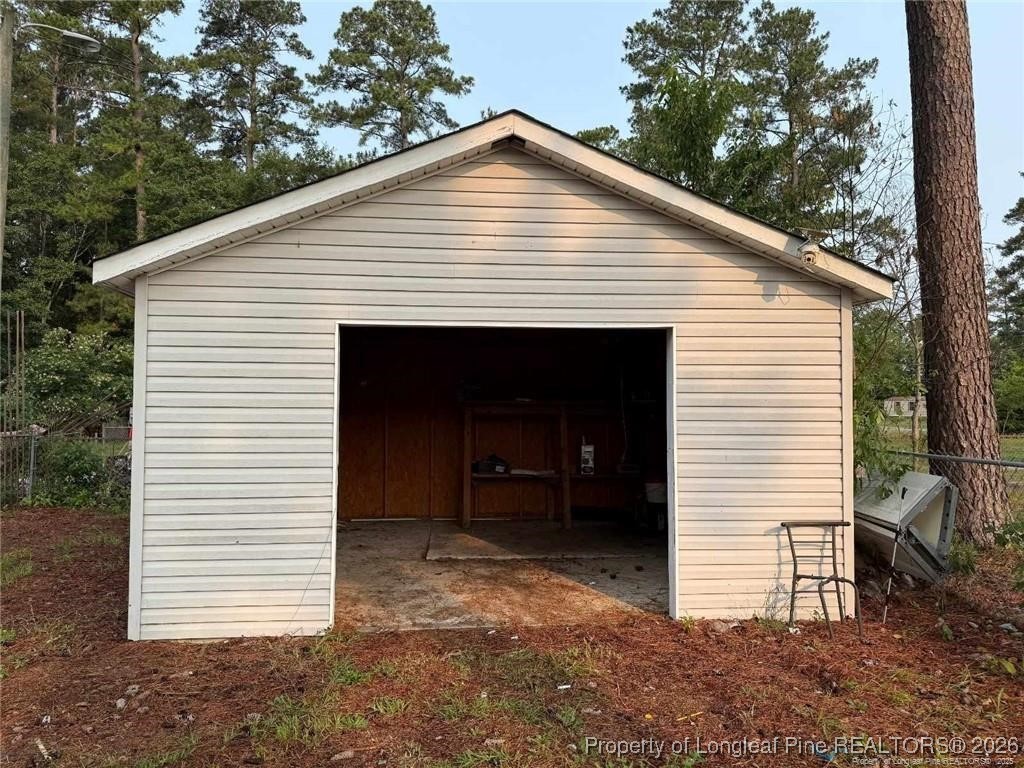 21040 McLaughlin Road Laurinburg, NC 28352 - Photo 3 of 14 a view of a small house with a garage and balcony
