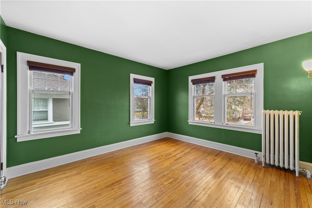 2891 Huntington Road Cleveland, OH 44120 - Photo 23 of 44 Unfurnished room featuring baseboards, hardwood / wood-style flooring, and radiator