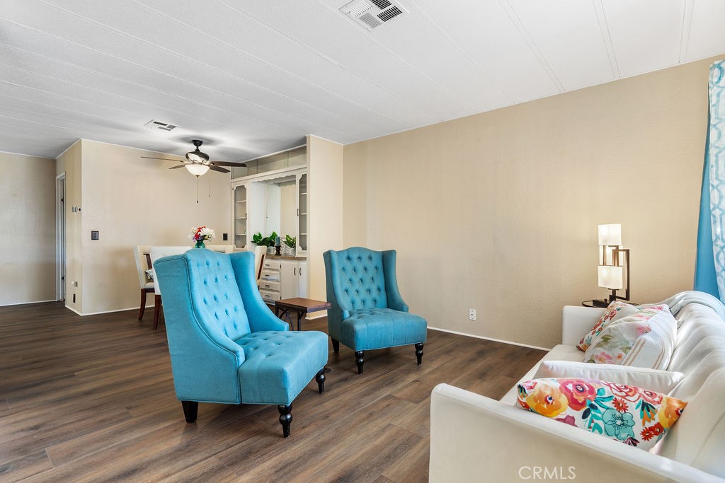 13393 Mariposa Road, Unit 99 Victorville, CA 92395 - Photo 12 of 50 a living room with furniture and a wooden floor