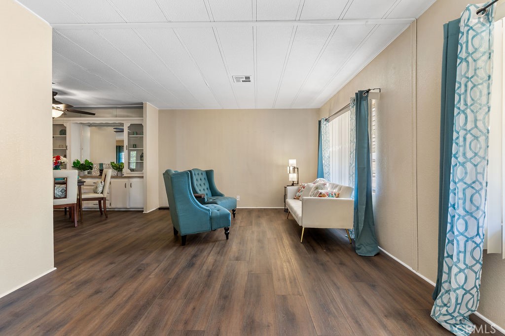 13393 Mariposa Road, Unit 99 Victorville, CA 92395 - Photo 13 of 50 a living room with furniture and wooden floor