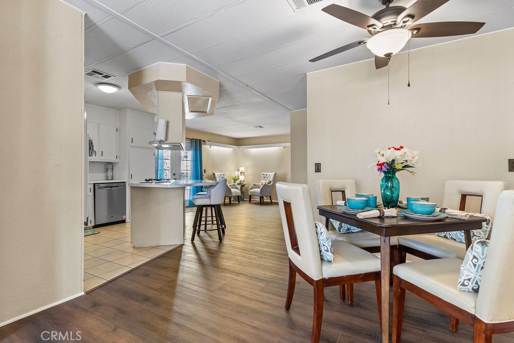 13393 Mariposa Road, Unit 99 Victorville, CA 92395 - Photo 15 of 50 a view of a dining room with furniture and wooden floor