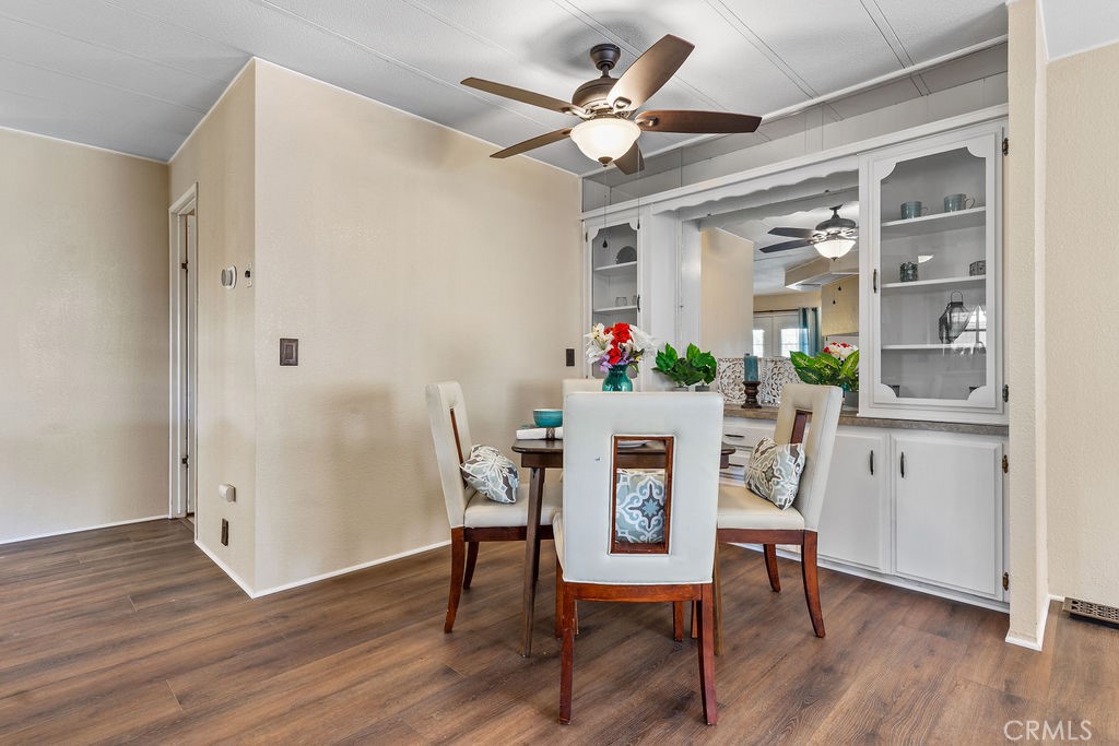 13393 Mariposa Road, Unit 99 Victorville, CA 92395 - Photo 16 of 50 a view of a dining room with furniture and wooden floor
