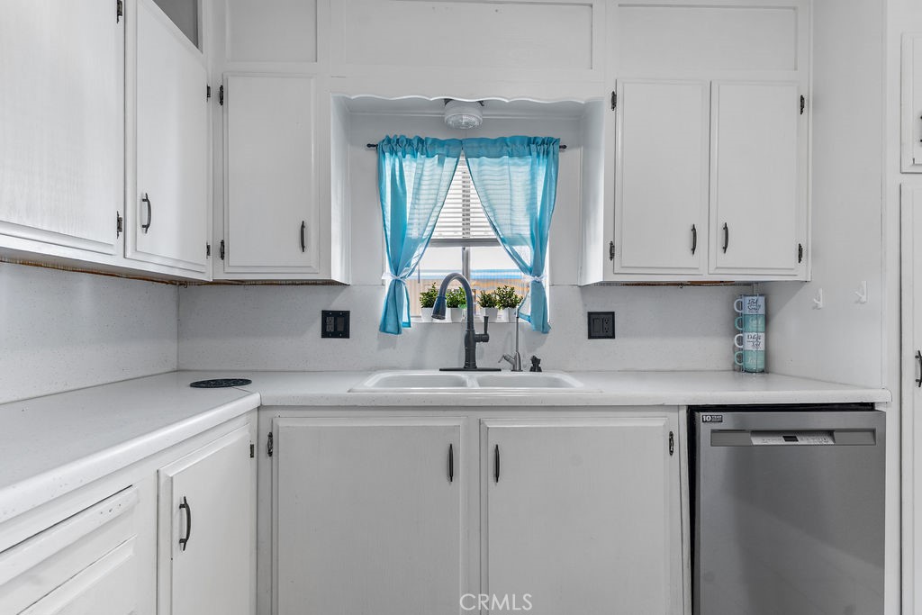 13393 Mariposa Road, Unit 99 Victorville, CA 92395 - Photo 21 of 50 a kitchen with stainless steel appliances granite countertop a sink a stove and cabinets
