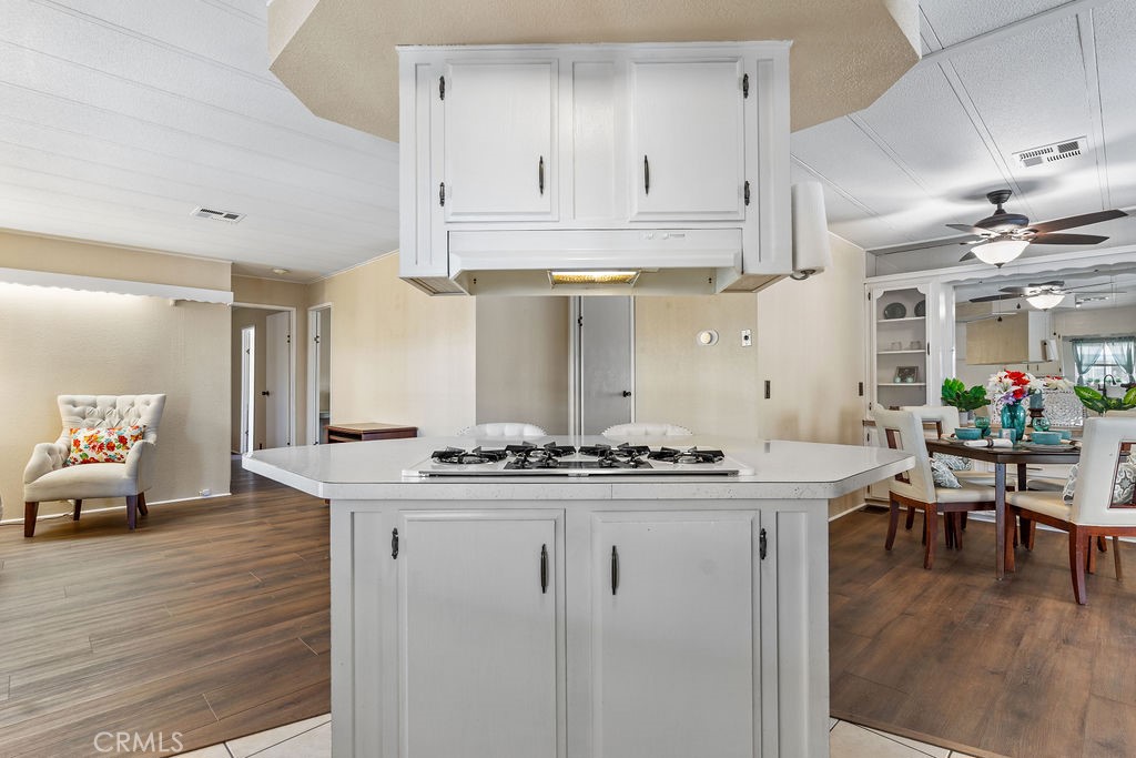13393 Mariposa Road, Unit 99 Victorville, CA 92395 - Photo 22 of 50 a kitchen with stainless steel appliances granite countertop a stove and white cabinets