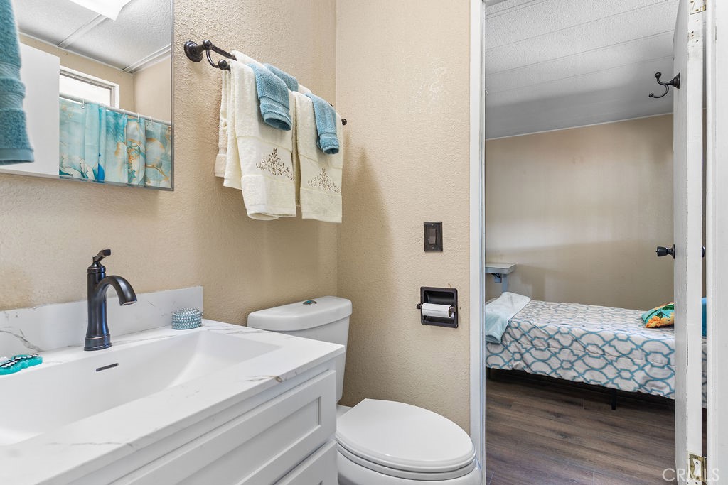 13393 Mariposa Road, Unit 99 Victorville, CA 92395 - Photo 31 of 50 a bathroom with a sink a toilet and shower