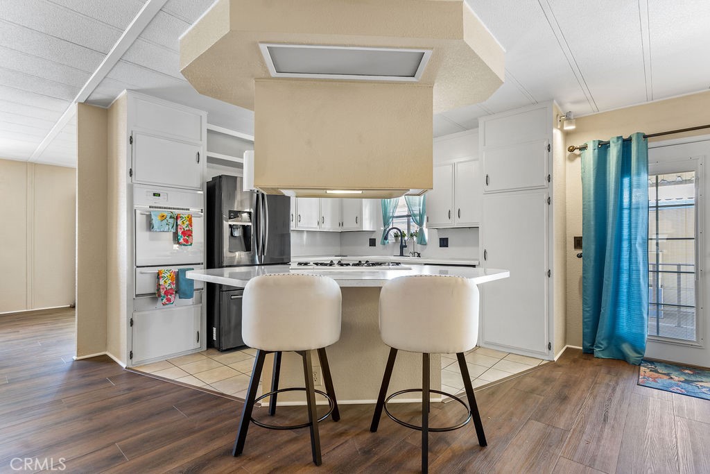 13393 Mariposa Road, Unit 99 Victorville, CA 92395 - Photo 33 of 50 a view of a dining room with furniture and wooden floor