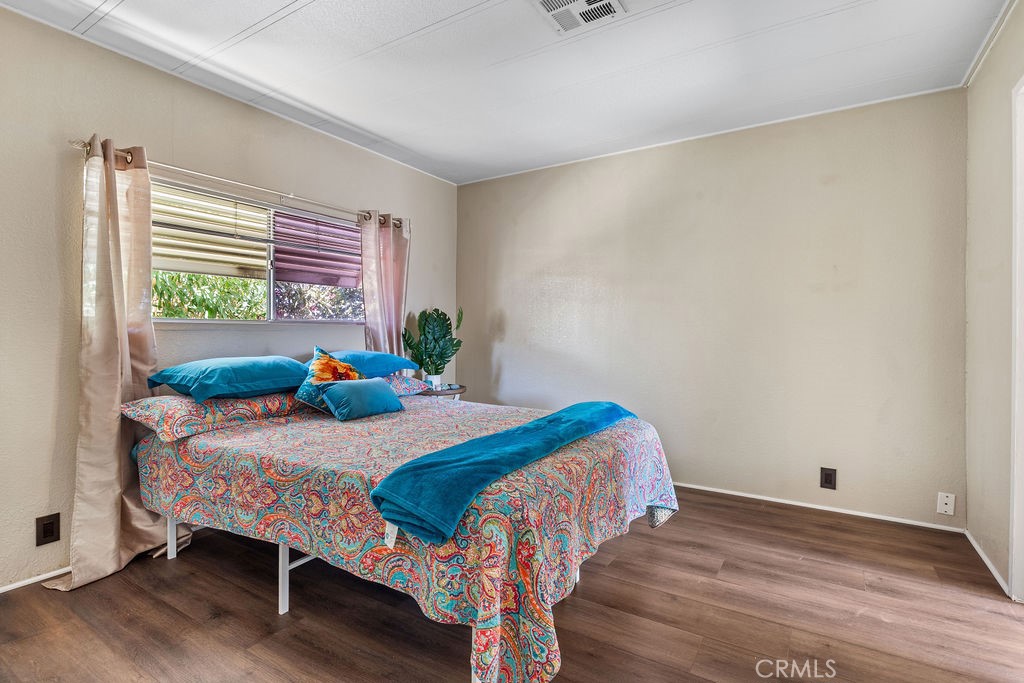 13393 Mariposa Road, Unit 99 Victorville, CA 92395 - Photo 34 of 50 a bedroom with a bed and a window