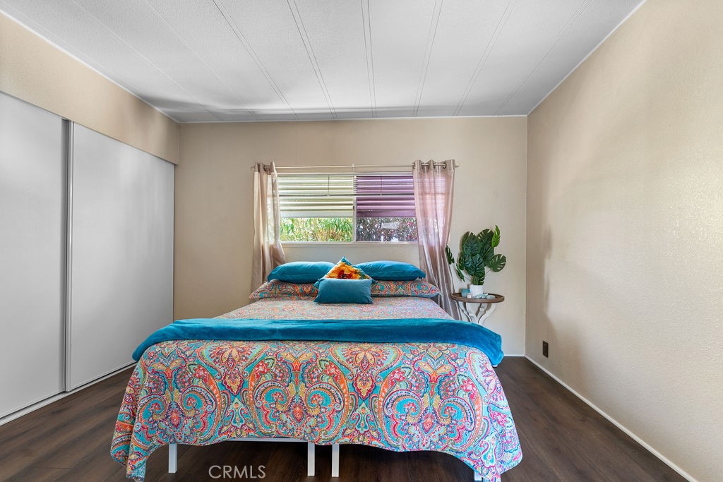 13393 Mariposa Road, Unit 99 Victorville, CA 92395 - Photo 37 of 50 a bedroom with a bed table and a window