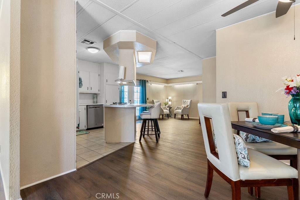 13393 Mariposa Road, Unit 99 Victorville, CA 92395 - Photo 44 of 50 a dining room with furniture and wooden floor